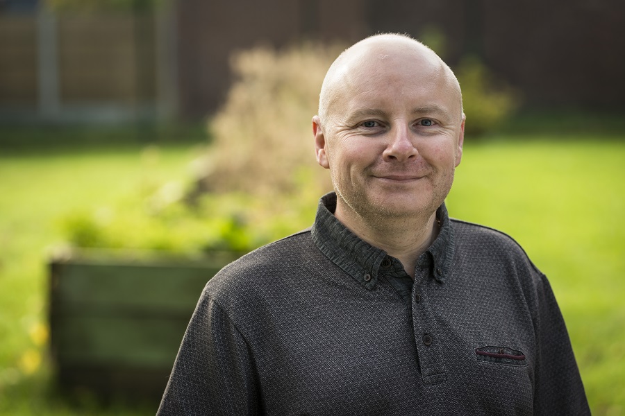 portrait of male volunteer stood outside