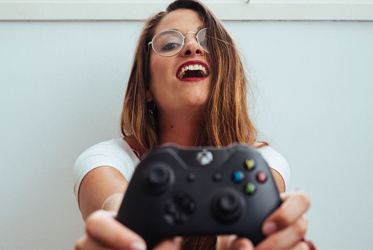Person smiling with a game console