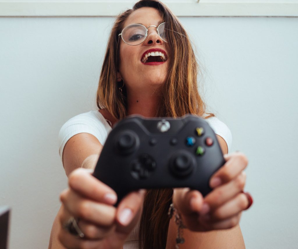 Person smiling with a game console