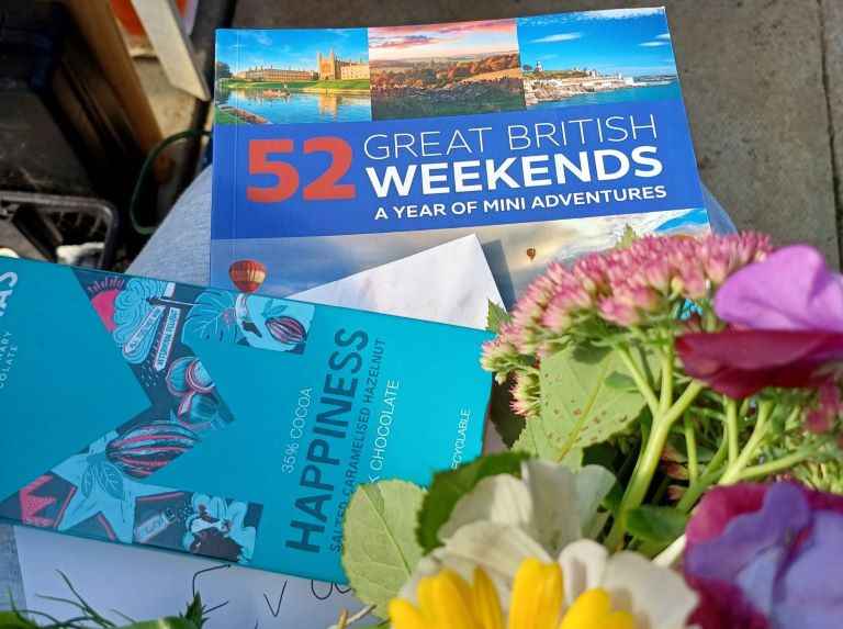 flowers, booklet and chocolate